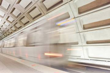 Blurred image of Washington D.C. metro arriving at underground station