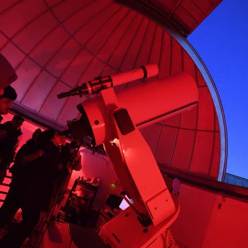 A large space telescope bathed in red light
