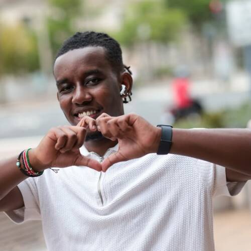 A man makes a heart symbol with his hands